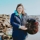 Naomi on the beach with a basket of freshly cut seaweed