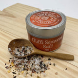 Tin of mild seaweed salt with wooden spoon of salt
