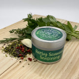 herby seaweed seasoning with fresh herbs, garlic and peppercorns on a wooden board